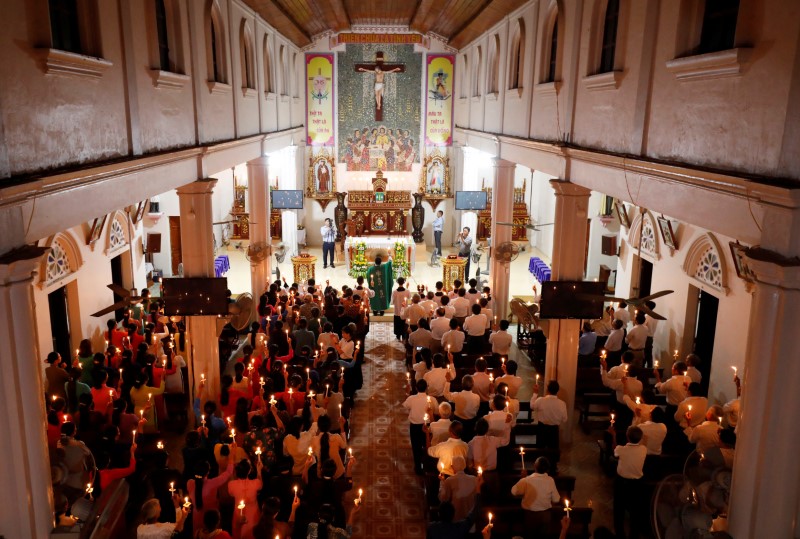 Catholics attend a mass prayer for 39 people found dead