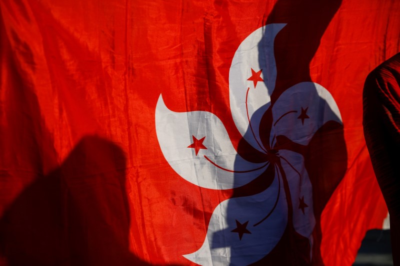 A shadow is cast on a Hong Kong flag as