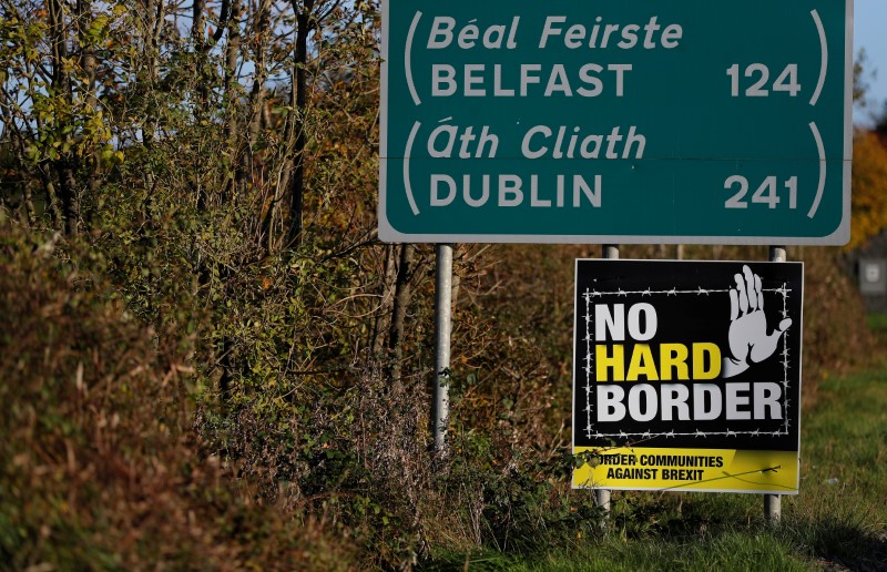 A ‘No hard Border’ poster is seen below a road