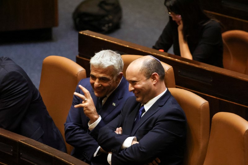 Prime Minister Naftali Bennett chats with Foreign Minister Yair Lapid,