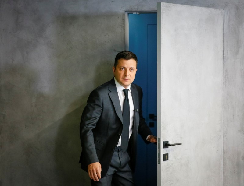 Ukrainian President Volodymyr Zelenskiy walks in for an interview in