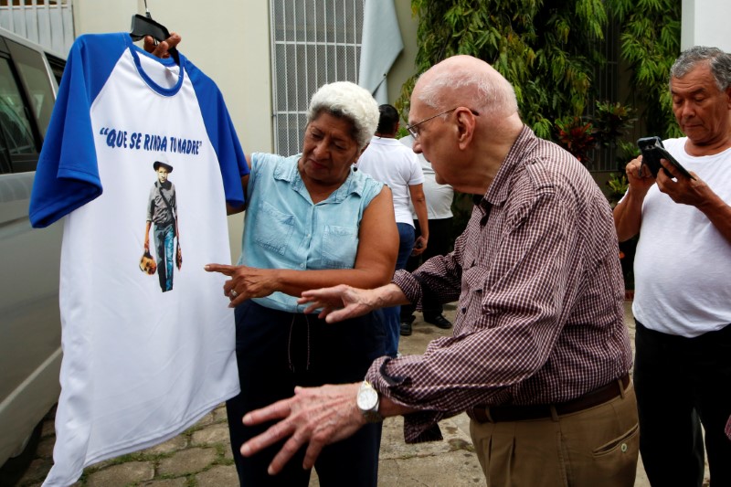 Former Nicaraguan President Bolanos buys a T-shirt after attending a