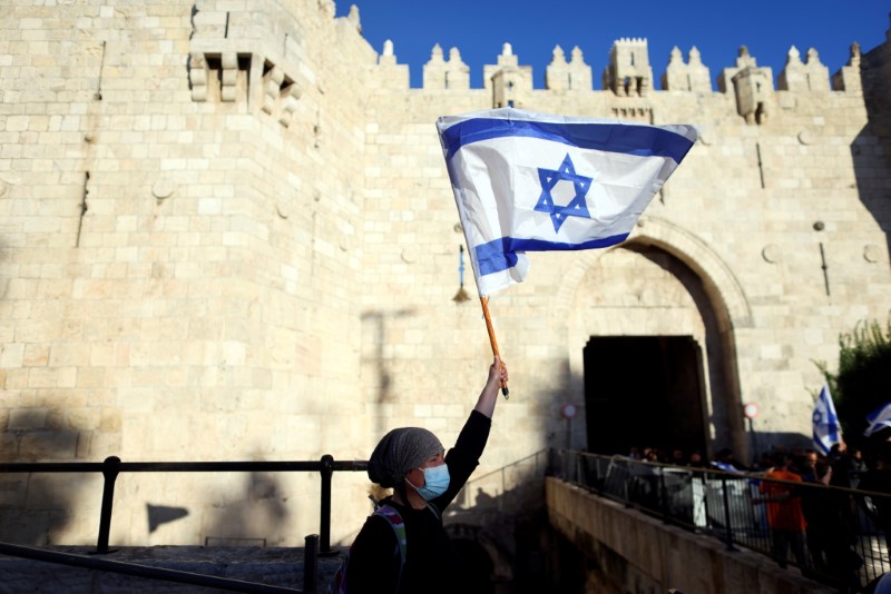 FILE PHOTO: Israeli woman holds a flag by Damascus gate