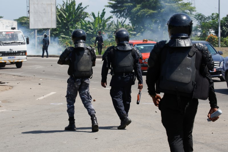 Members of the security forces disperse supporters of former Ivorian