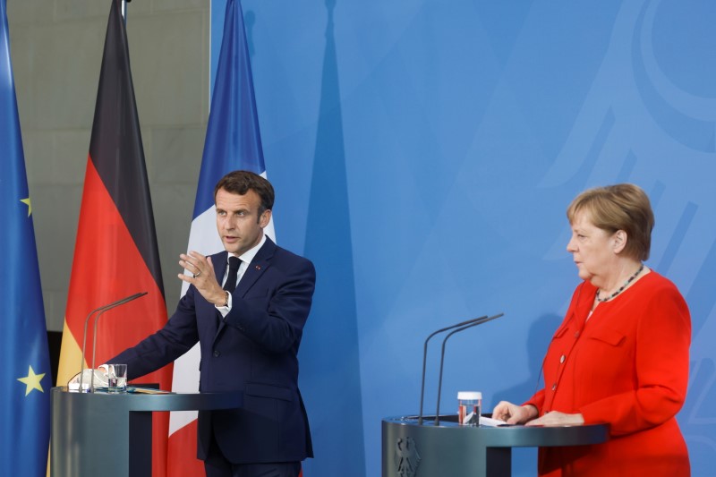 German Chancellor Angela Merkel and French President Emmanuel Macron give