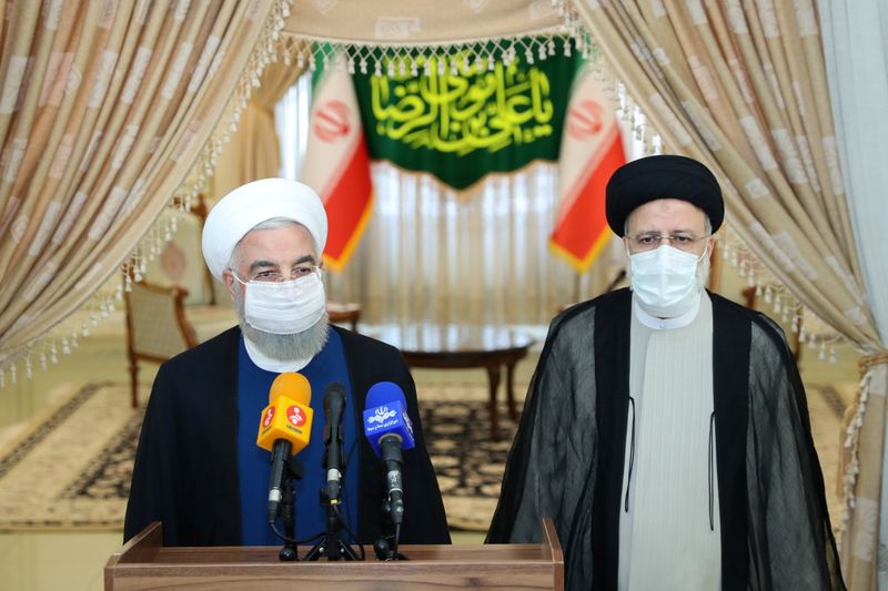 Iran’s outgoing President Rouhani and Iran’s President-elect Raisi speak to
