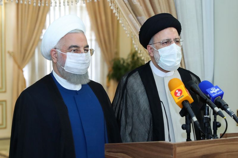 Iran’s outgoing President Rouhani and Iran’s President-elect Raisi speak to