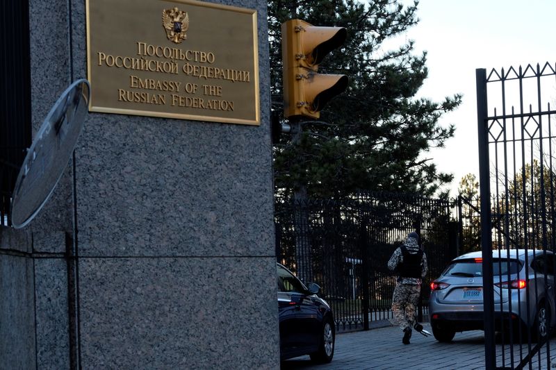 A guard screens cars entering the Russian embassy on Wisconsin