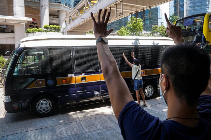 FILE PHOTO: Supporters bid farewell to a prison van transporting