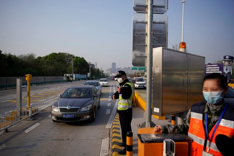 Police officer directs vehicles at a toll station of an