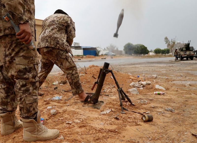 A fighter loyal to Libya’s U.N.-backed government (GNA) fires a