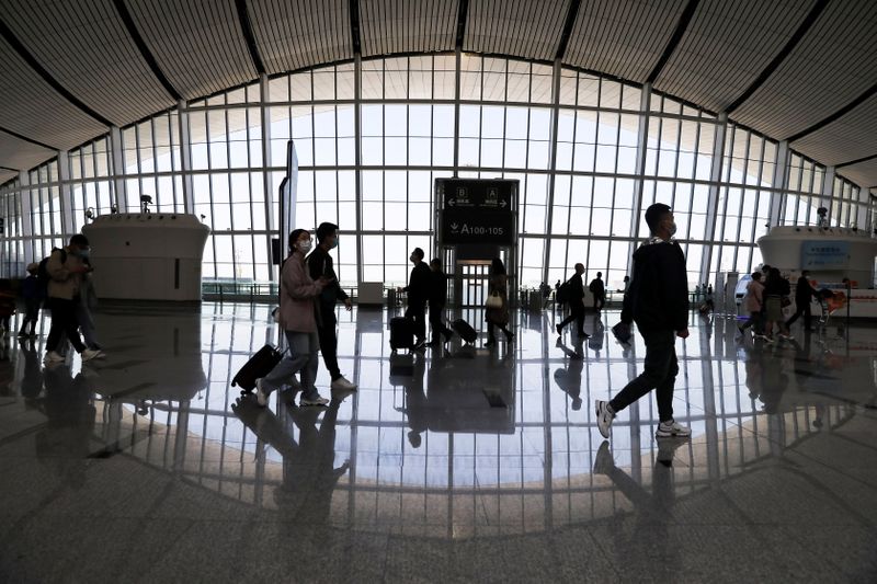 FILE PHOTO: Travellers are seen at the Beijing Daxing International