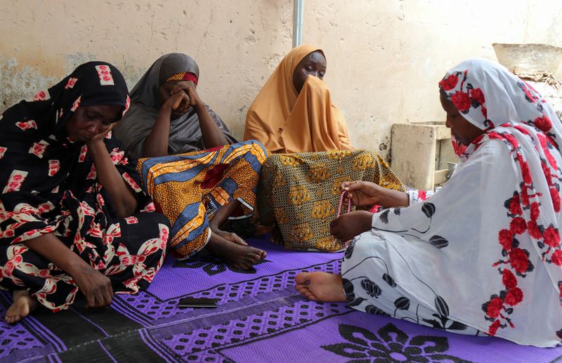 Women mourn the death of one of the aid workers