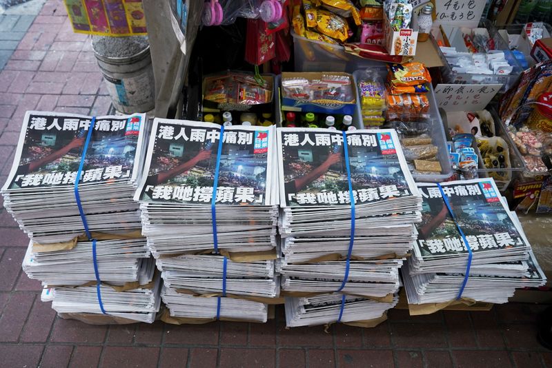 Copies of the final edition of Apple Daily are seen
