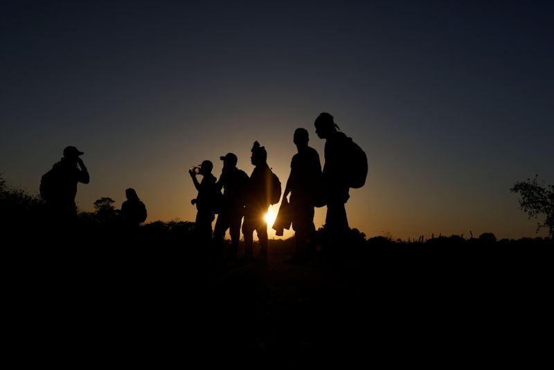 A group of migrants from Honduras take a short rest
