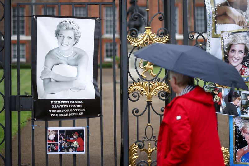 A person looks at tributes for Britain’s Princess Diana, outside