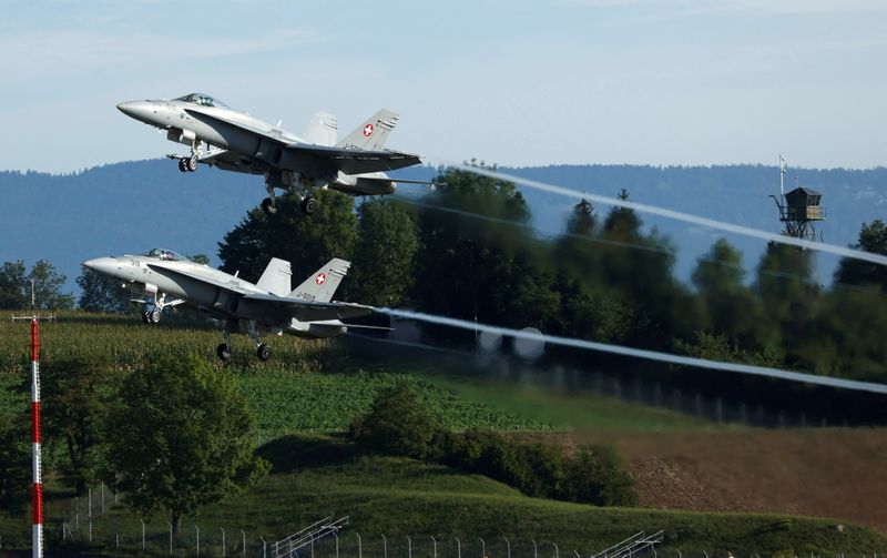 FILE PHOTO: Two F/A-18 Hornet fighter jets of the Swiss