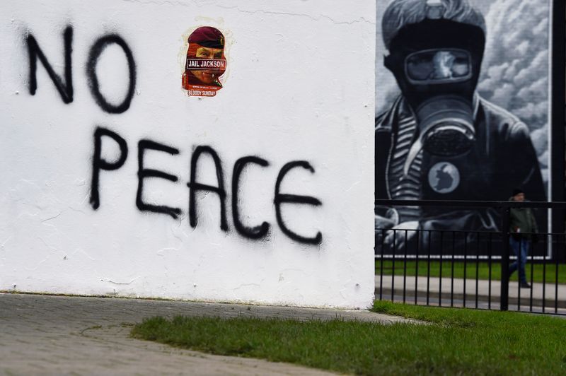 A fresh graffiti “No Peace” is seen on a wall