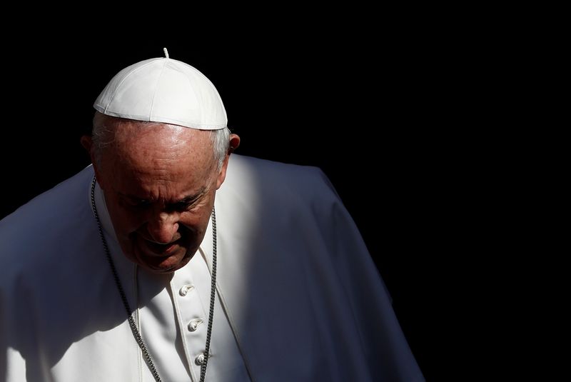 FILE PHOTO: Pope Francis walks after the weekly general audience