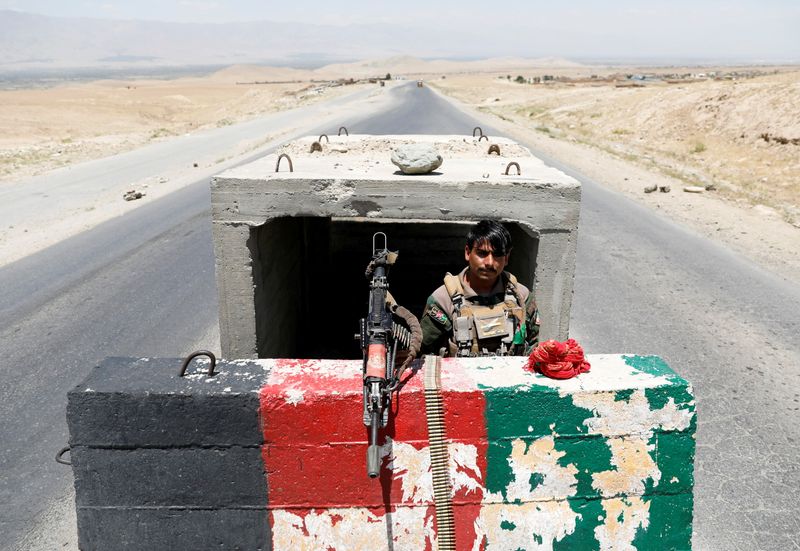 FILE PHOTO: Afghan National Army soldier stands guard at checkpoint