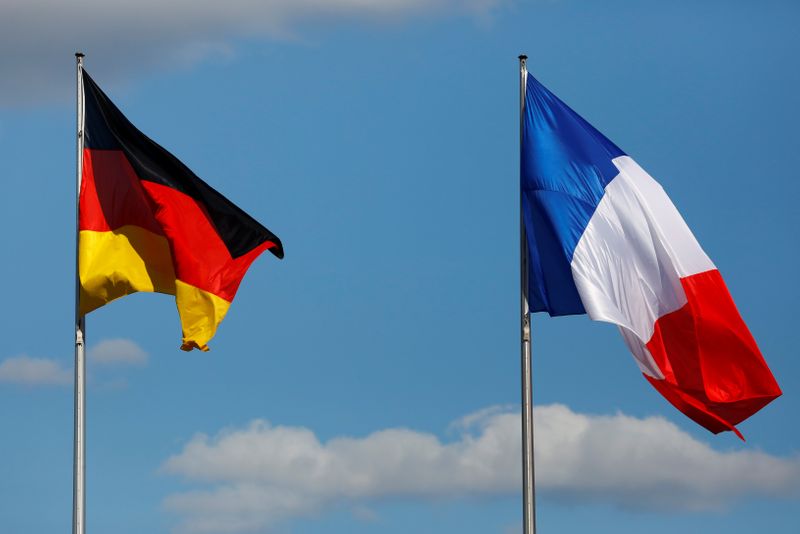 The flags of Germany and France are seen in front
