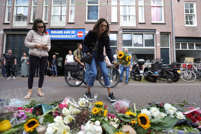 People leave flowers where Dutch crime reporter de Vries has