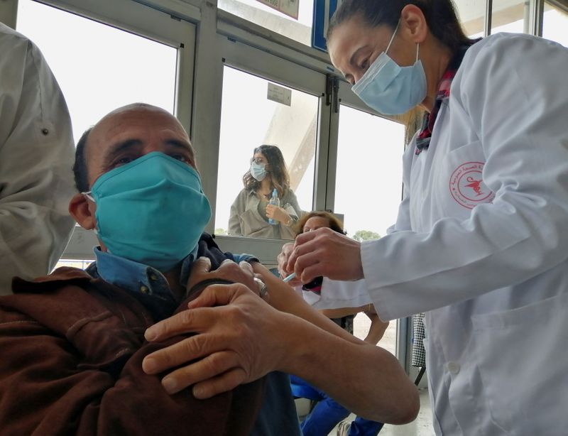 A man receives a COVID-19 vaccine in Tunis