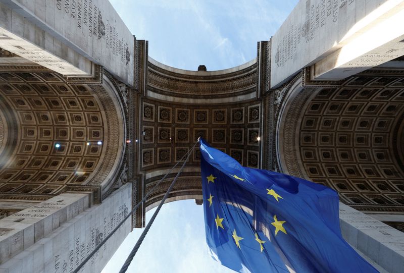 The European flag flies under the Arc de Triomphe to