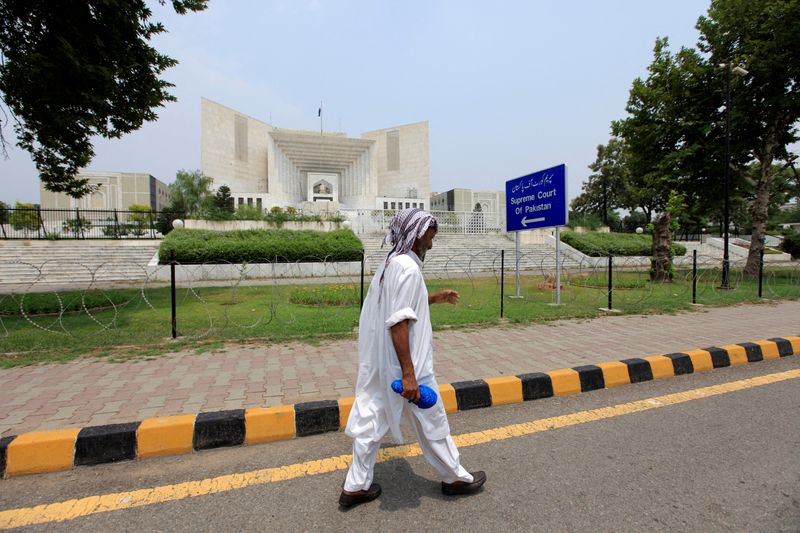 FILE PHOTO: File photo of man walking past the Supreme