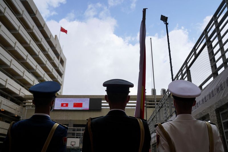 Members of People’s Liberation Army attend a morning flag-raising assembly