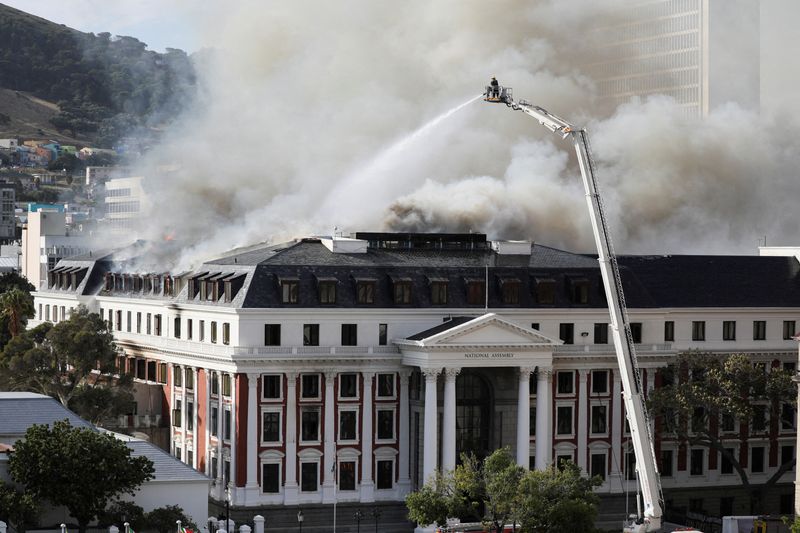 FILE PHOTO: Firefighters work at the parliament as the fire