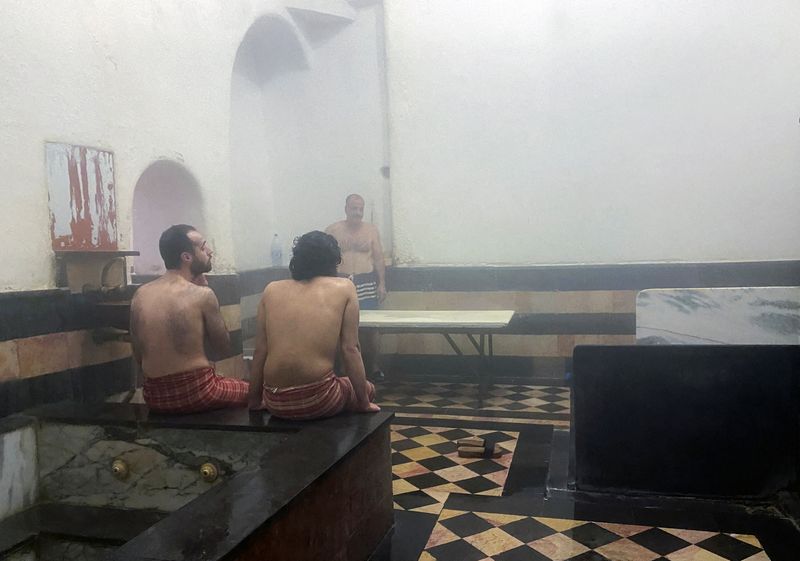 Men wait for their turn at a bathhouse in Damascus