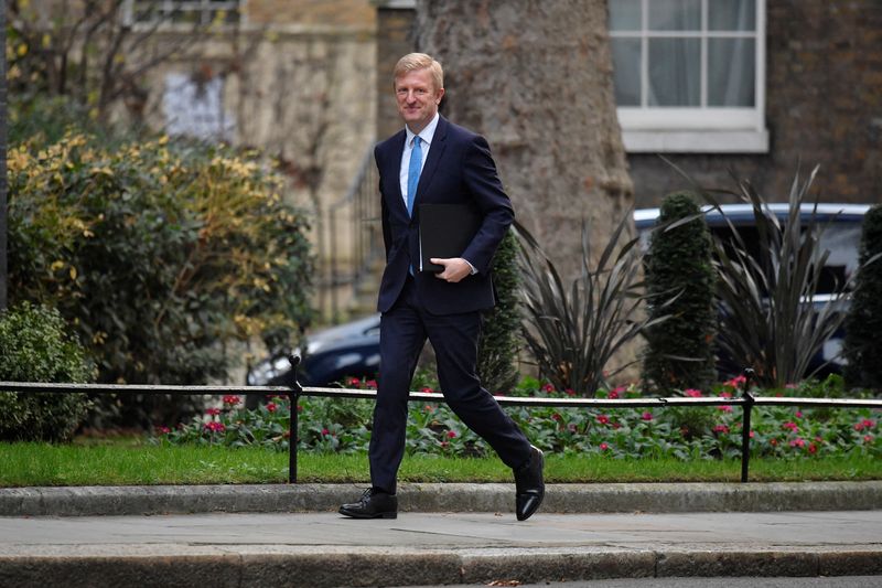 Co-Chairman of British Conservative Party Dowden walks on Downing Street