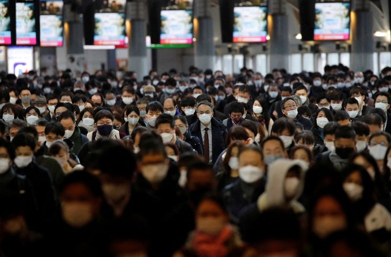 Commuters wearing protective face masks amid the COVID-19 pandemic make