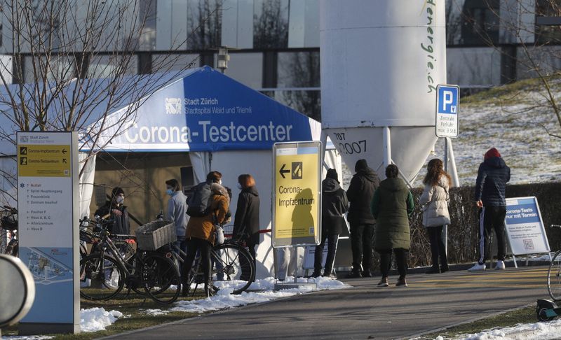 FILE PHOTO: People queue at a coronavirus disease (COVID-19) tests