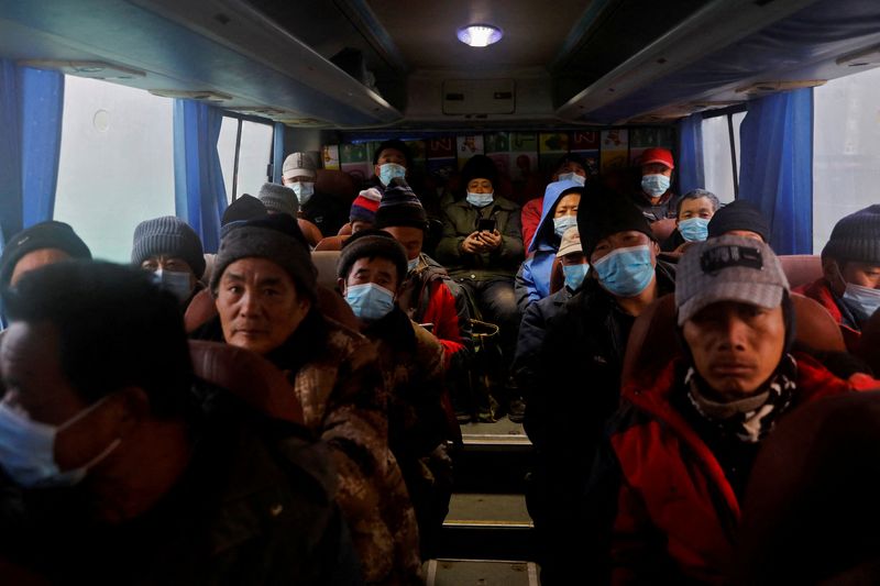 FILE PHOTO: Beijing’s migrant workers on a shuttle bus