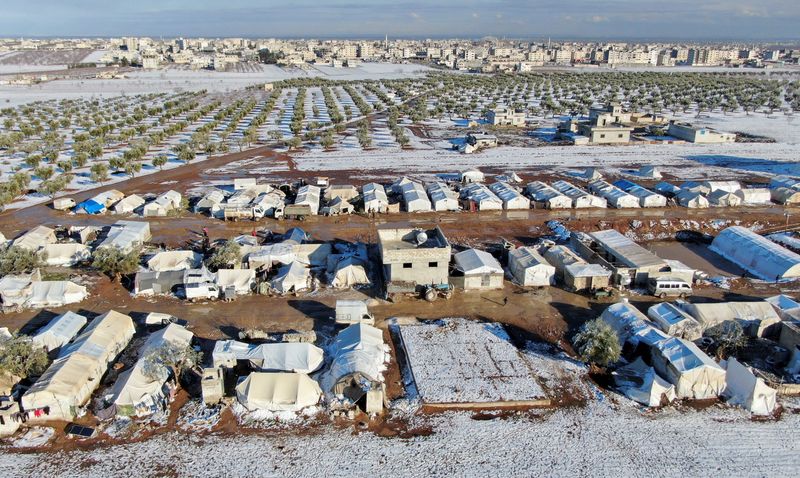 A general view of a partially snow covered camp for
