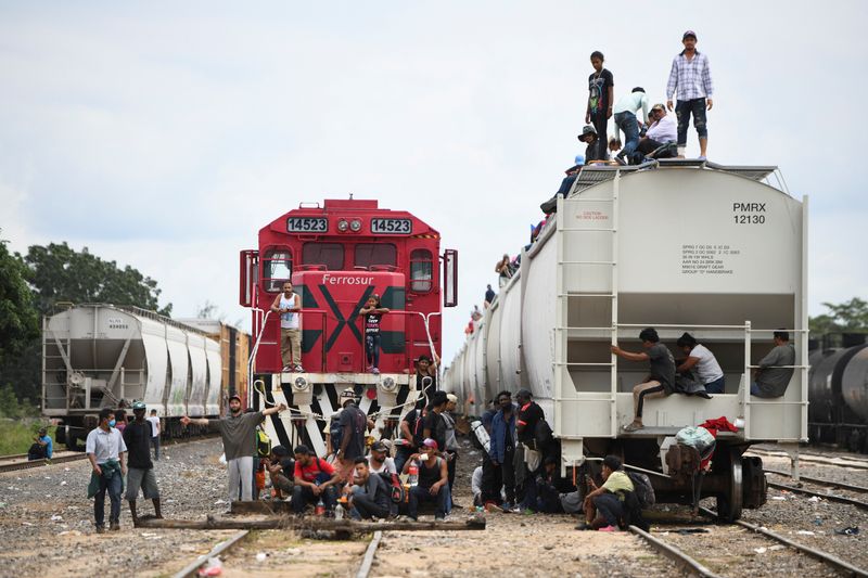 Migrants heading to Mexico City wait for a freight train