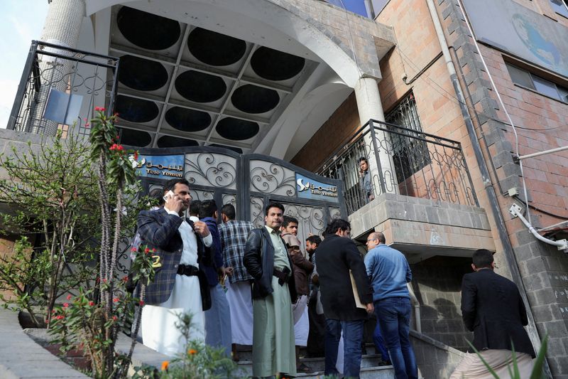 People wait outside TeleYemen company to get satellite internet connection