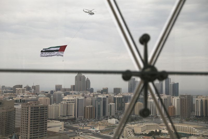 FILE PHOTO: A helicopter flies over the downtown skyline of