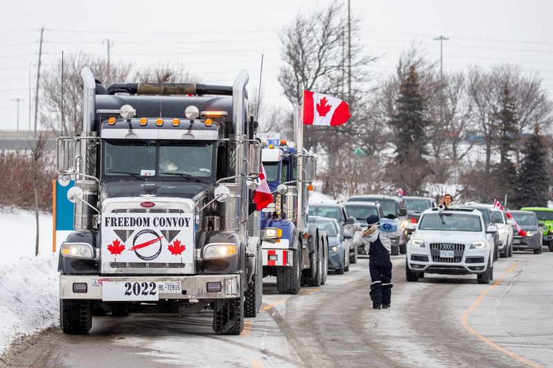 Truckers drive through Toronto on their way to Ottawa to