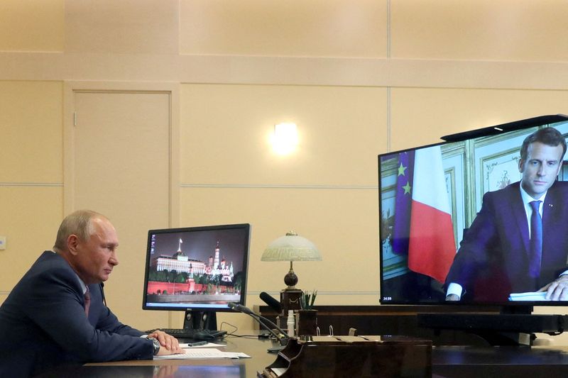 FILE PHOTO: Russia’s President Putin speaks with his French counterpart