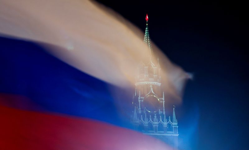 Russian flag flies with the Spasskaya tower of Moscow’s Kremlin