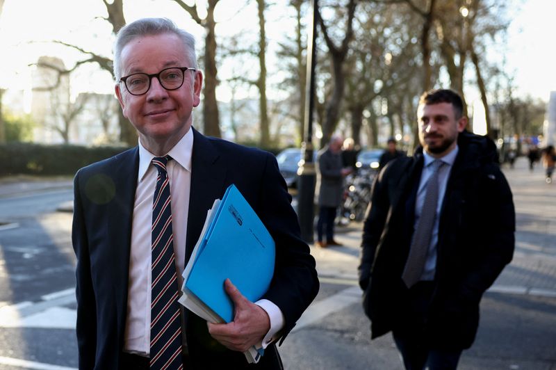British Housing Secretary Gove walks outside Houses of Parliament in