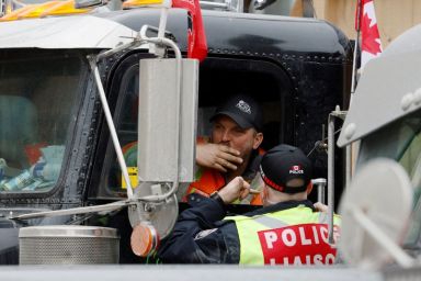 Trucker speaks with an Ottawa police officer as protests against