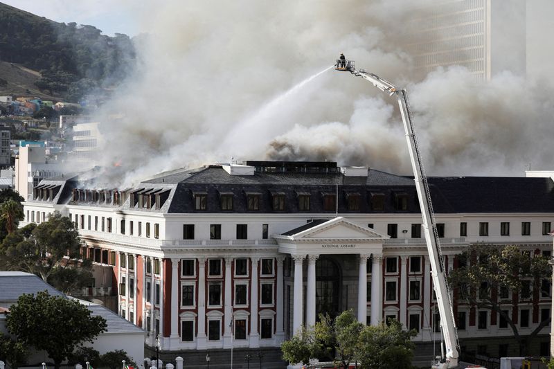 FILE PHOTO: Firefighters battle flames at South Africa’s parliament, in