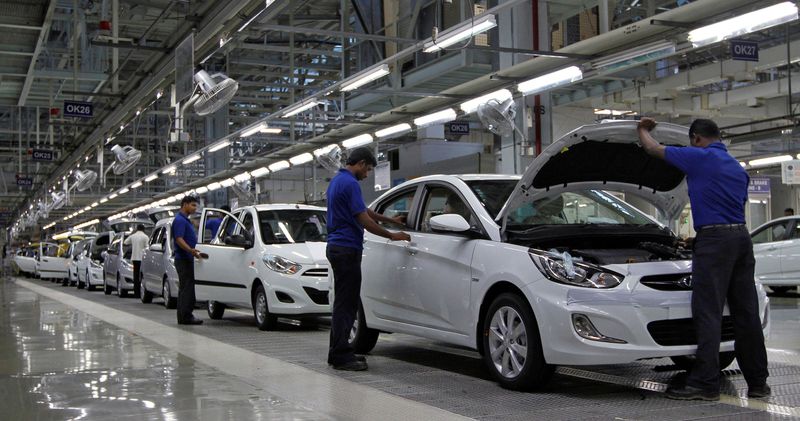 FILE PHOTO: Workers assemble cars inside the Hyundai Motor India