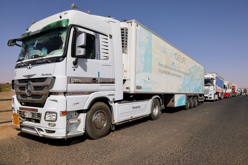 Egyptian trucks wait as the road between Sudan and Egypt