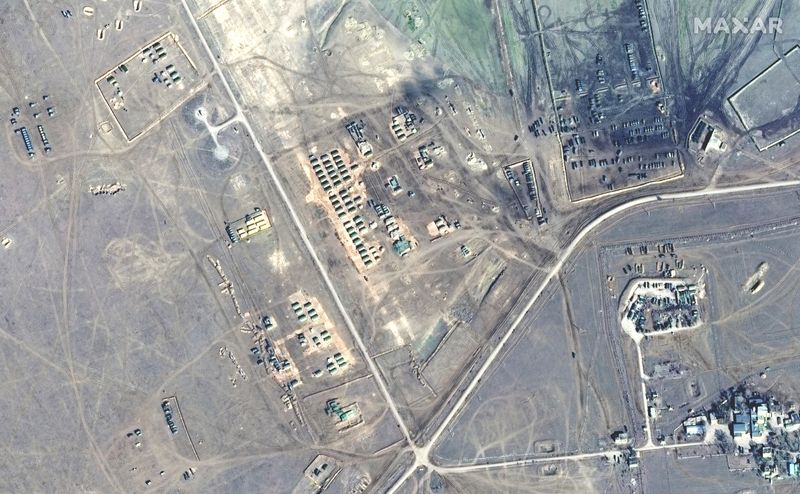 A satellite image shows tents and artillery at Opuk training