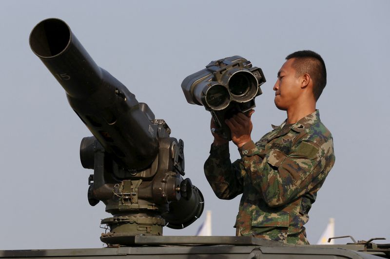 FILE PHOTO: A Thai soldier prepares his equipment as they